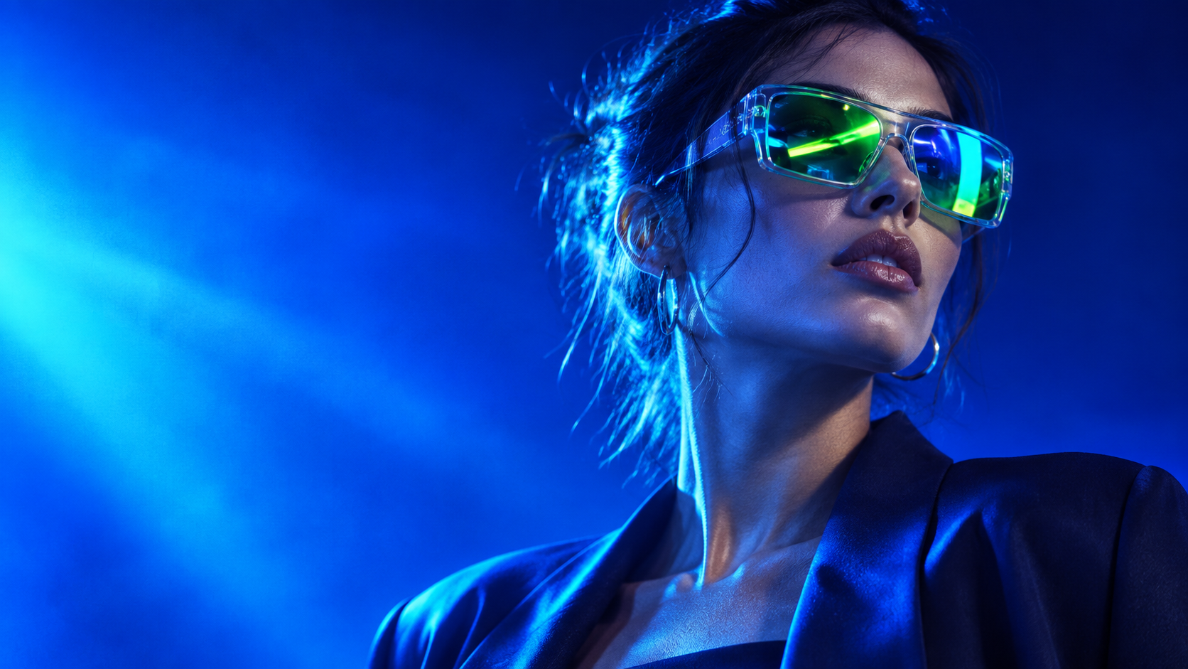 Blue-lit editorial portrait with neon-lime reflections in sculptural eyewear